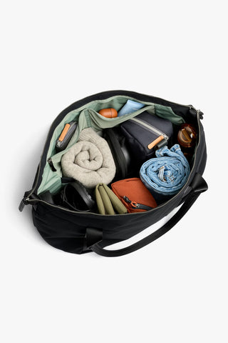 Black duffel bag open, top view showing interior organizers and rolled clothing