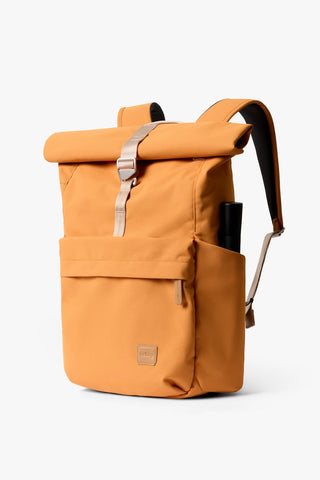 Butterscotch roll-top backpack with silver buckle and front storage pocket