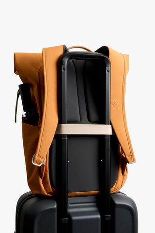 Butterscotch roll-top backpack open to show black interior organizer and straps