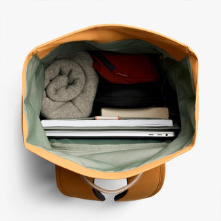Butterscotch roll-top backpack open top showing gray knit and electronics sleeve