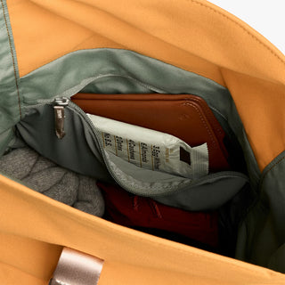 Butterscotch roll-top backpack interior pocket with zipper and fabric label
