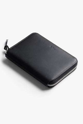 Black leather folio wallet closed with zip and corner stitching