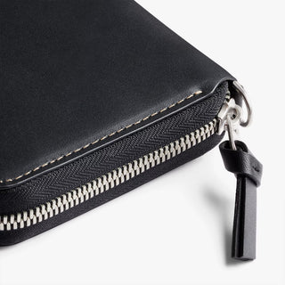 Black zip folio wallet with silver zipper pull and leather key fob