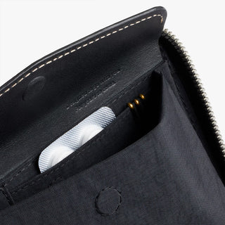 Black folio wallet interior showing card slot and fabric pocket