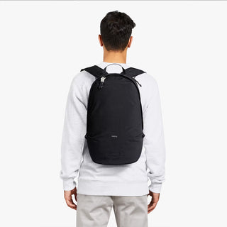 Black daypack rear view with padded back panel and adjustable shoulder straps