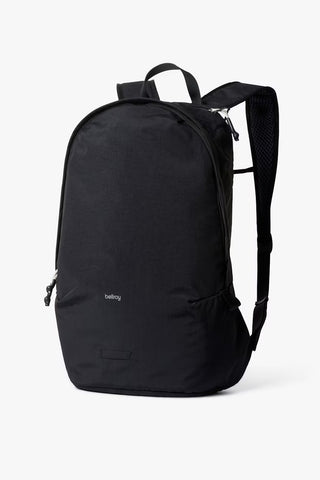 Black minimalist daypack with top handle and front zipper pocket