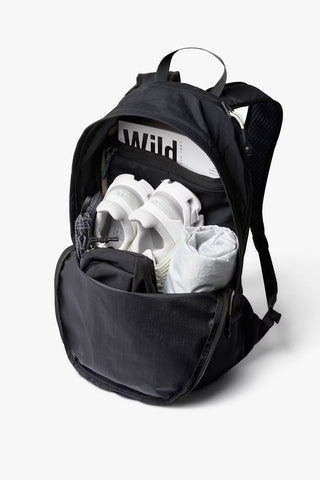 Black daypack open showing inner compartments and organizer pocket