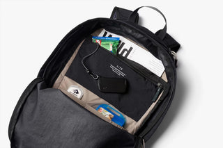 Black daypack interior with laptop-size sleeve and zip pocket