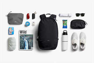 Black daypack with pack-out style accessories display; backpack closed