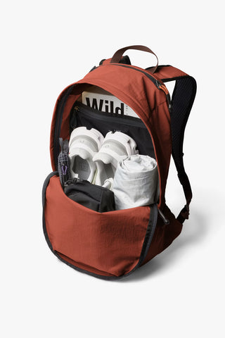 Clay-brown daypack with top opening, showing internal pocket and hanging strap