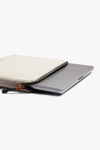 Bellroy Lite laptop sleeve opened flat, ash outer with laptop inside and zipper tab