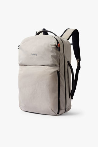 Light gray travel backpack with top handle, front zip pocket, and black shoulder straps