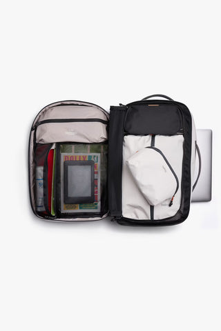 Light gray backpack opened to show main compartment and inner zip pouches with dividers