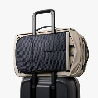 Light gray backpack with suitcase sleeve and black front organizer panel