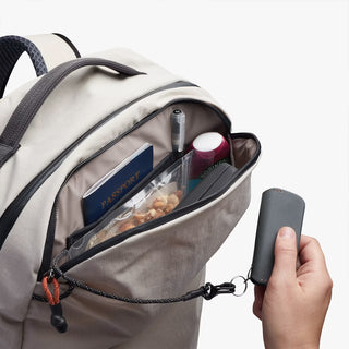 Light gray backpack side view with zip front pocket and clear organizer panel
