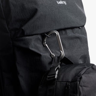 Black bellroy backpack with front flap zipper pull and metal carabiner clip