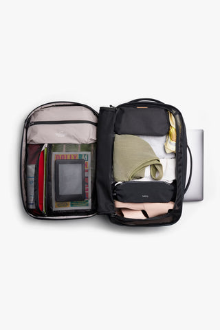 Black bellroy backpack opened to show multiple internal compartments and pouches