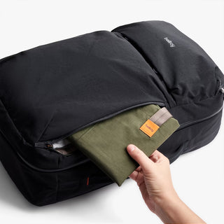 Black bellroy backpack open top compartment with green lining and zip divider