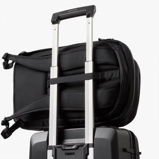Black backpack with extended carry handle and luggage-strap attachment
