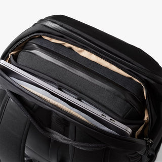 Black backpack top compartment with multiple zip pockets and tablet/laptop sleeve section