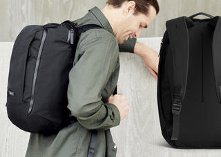 Black work backpack with curved back panel and side zipper pocket