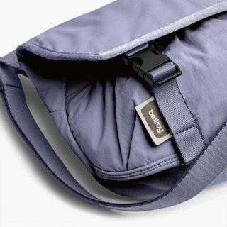 Lilac mini messenger bag with inner brand label and adjustable strap buckle