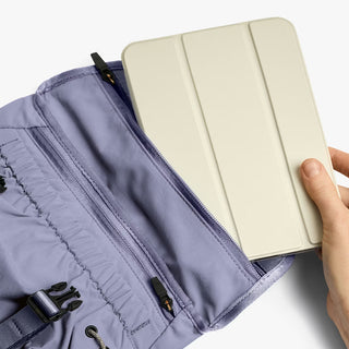 Lilac mini messenger bag with zip opening accommodating a tablet-sized device
