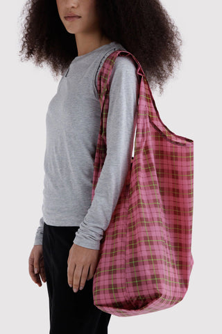Big BAGGU tote in pink tartan plaid, carried over shoulder by model