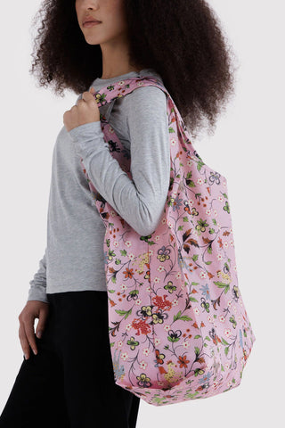 Large BAGGU tote bag with pink floral print worn on shoulder