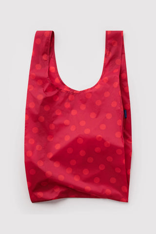 Red polka dot reusable shopping bag with U-shaped opening and short handles