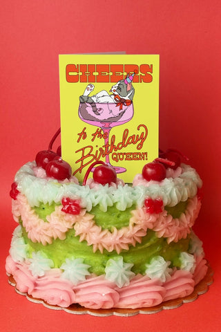 Birthday Queen card topper on a decorated layered birthday cake