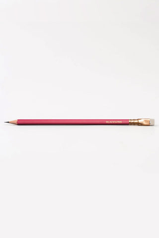 Matte red pencil with gold ferrule and sharpened graphite point