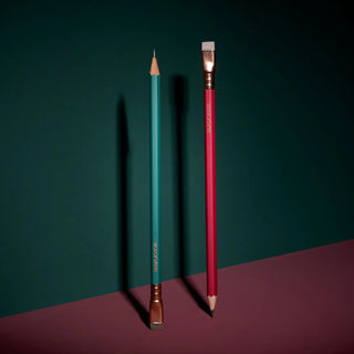 Red and teal pencils standing upright, sharpened wood tips and gold ferrules