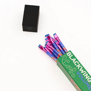 Pencil set in green box opening with multiple patterned blue pencils and pink ends