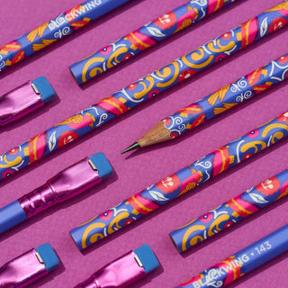 Decorative pencils with blue patterned design and pink metal ferrules laid out