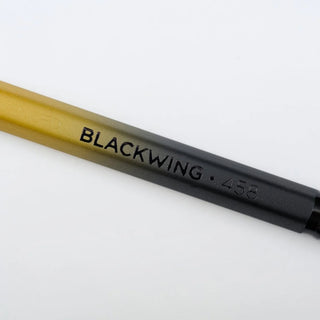 Blackwing 458 pencil with gold barrel and black tip, printed BLACKWING 458