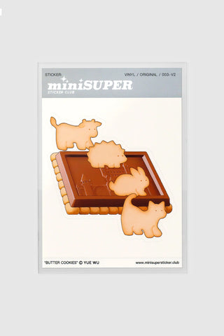Butter cookie sticker with three cartoon animal shapes on a brown tray, vinyl style