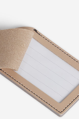 Tan leather luggage tag interior card sleeve with white insert and stitched edges