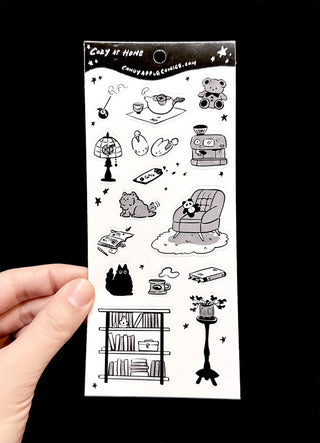 Cozy at-home sticker sheet with black line-art room, robot and cat doodles
