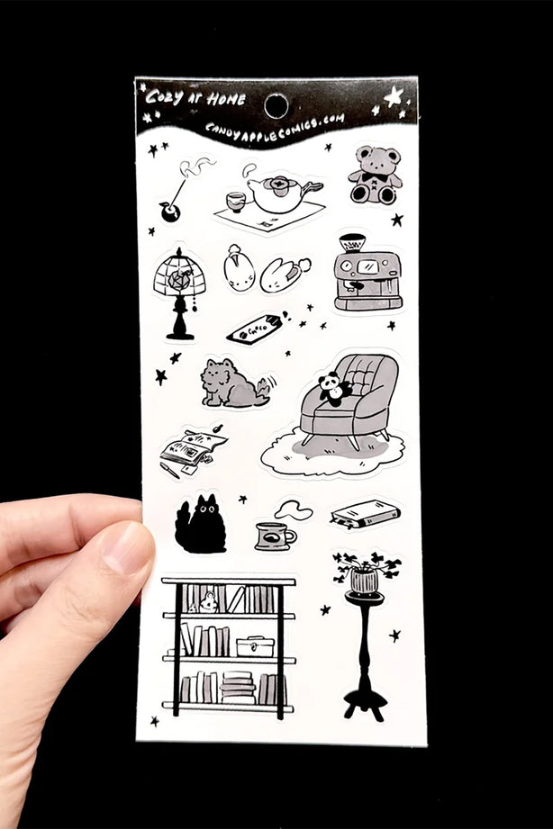 Cozy at-home sticker sheet with black line-art room, robot and cat doodles