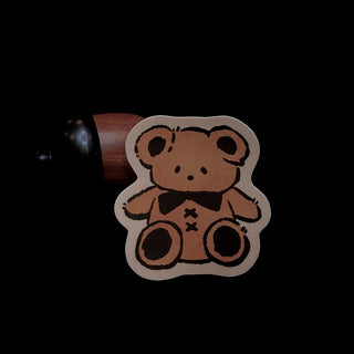 Cute cartoon bear vinyl sticker with bow tie, outlined in black