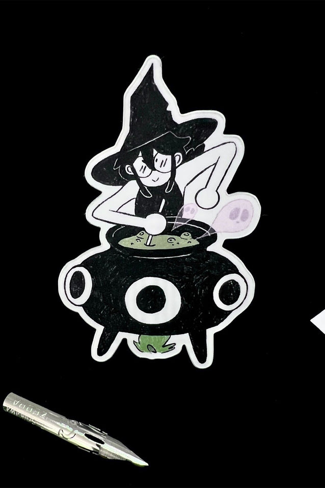 Cartoon witch cauldron sticker with purple potion bubble and green spell scroll