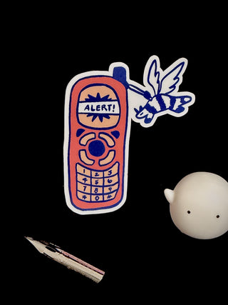 Vinyl sticker of cartoon blue-outlined alert phone with “ALERTS” label and keypad