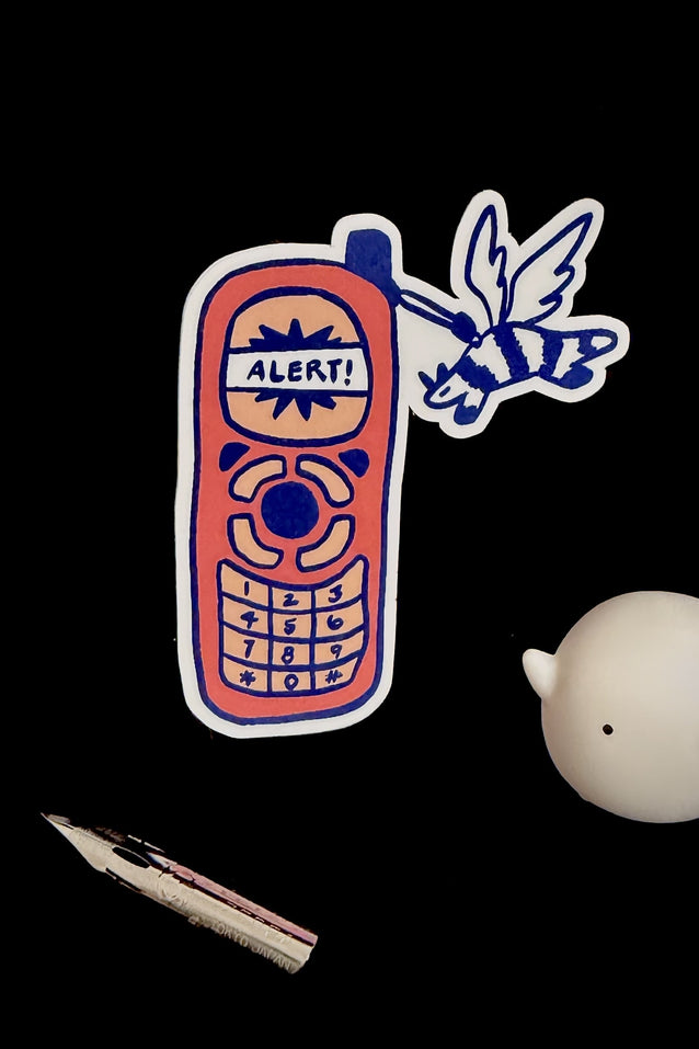 Vinyl sticker of cartoon blue-outlined alert phone with “ALERTS” label and keypad