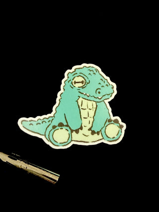 Mint green cartoon crocodile sticker with white outline