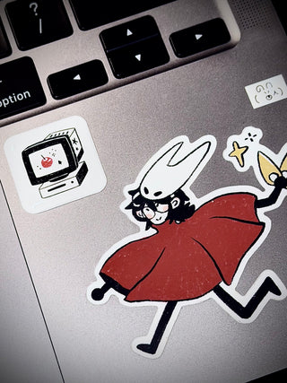 Die-cut bubble sticker of a cartoon cat in a red dress with computer icons