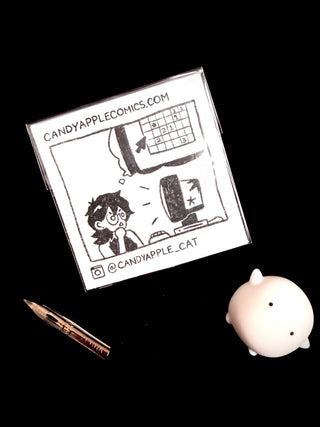 Square bubble sticker with black-and-white characters, cat logo, and a website URL
