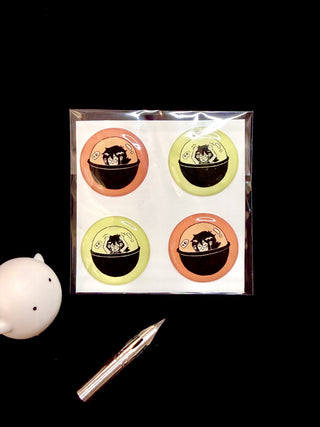 Bubble sticker sheet with four circular character stickers in orange and lime