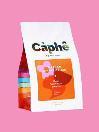 Angled white coffee bag with Caphe Roasters Vietnam single-origin label and Light badge