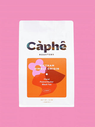 White coffee bag with Caphe Roasters Vietnam single-origin label, light roast flavor notes